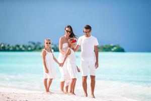 Young family of four on vacation have fun photo