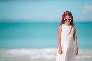 Portrait of beautiful girl on the beach dancing photo