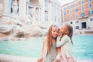 Adorable little girls near the Fountain of Trevi in Rome. photo