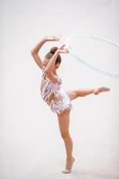 Little gymnast training on the carpet and ready for competitions photo