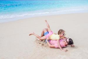 Family of father and sporty little girl having fun on the beach photo