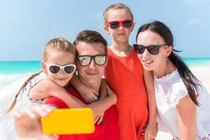 Young beautiful family taking selfie portrait on the beach photo
