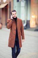 Happy young man walking at autumn day photo