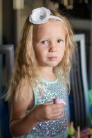 Portrait of adorable little girl looking at camera photo