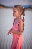 Adorable little girl on tropical beach vacation photo