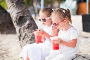 Portrait of little adorable girl on a tropical white beach photo