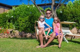 Father and kids at tropical beach vacation having fun outdoor photo