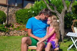 Young father and little daughter at tropical vacation having fun outdoor photo