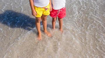 Closeup of little girls legs at shallow water photo