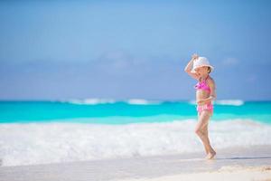 Adorable little girl at beach during summer vacation photo