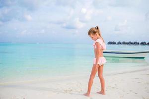 Adorable little girl during beach vacation having fun photo