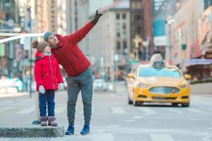 Family of father and little kid on Times Square during their vacation in New York City photo