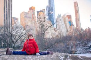Adorable little girl with view of ice-rink in Central Park at New York City photo