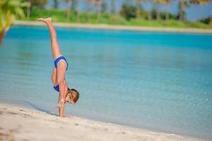 Adorable little girl at beach during summer vacation photo