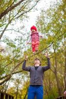 Young father with his cute little daughter have fun outdoor in the park photo