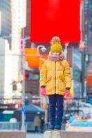 Adorable little girl have fun on Times Square in New York City photo