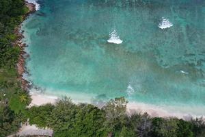 waves on reef in seychelles paradise beach aerial drone panorama landscape photo