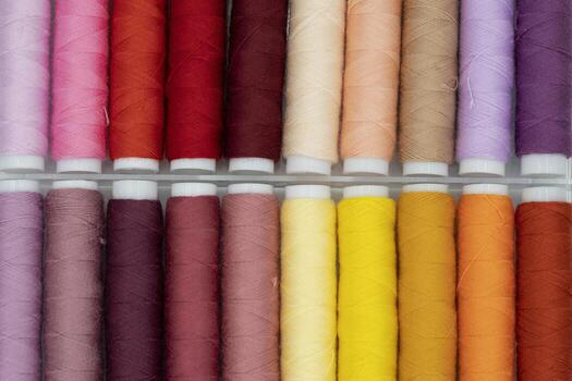spool of thread many of different colors isolated on white photo