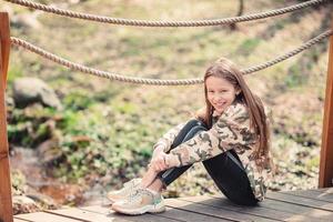 Little girl in outdoor park on her weekend photo