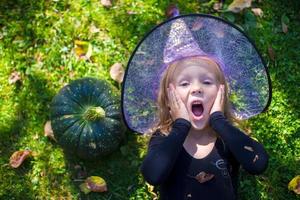 Cute little girl in Halloween which costume have fun outdoor photo