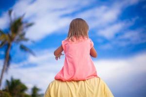 Little girl have fun with her dad at tropical beach photo