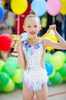 Beautiful little gymnast training on the carpet and ready for competitions photo