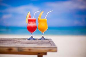 Two cocktails fresh watermelon and mango on background of stunning turquoise sea photo