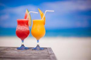 Two cocktails fresh watermelon and mango on background of stunning turquoise sea photo