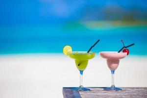 Two tasty cocktails on tropical white beach photo