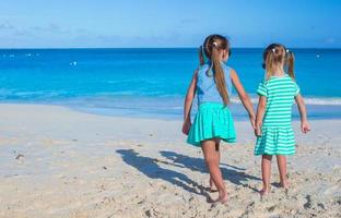Back view of little girls enjoying summer beach vacation