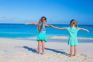 Little adorable girls enjoy summer beach vacation