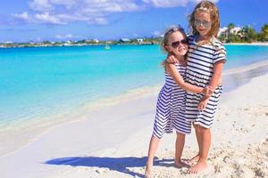 Adorable little girls enjoying summer beach vacation photo