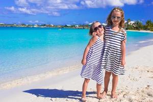 Little girls having fun during tropical beach vacation photo