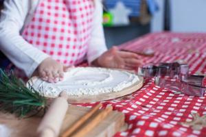 Flour on the board and kid's hands photo