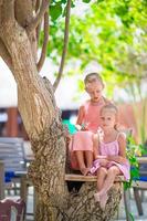 Adorable little girls during beach summer vacation photo