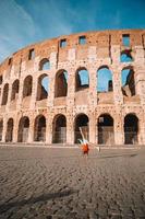 Little girl in front of colosseum in rome, italy photo