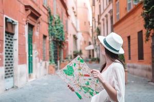 Travel tourist woman with map in Prague outdoors during holidays in Europe. photo