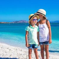 Little girls enjoy their summer vacation on the beach