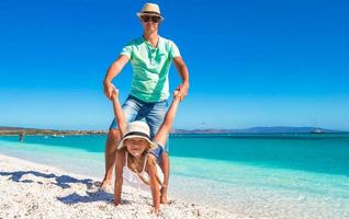 Happy dad and little girl have fun on tropical vacation