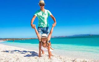 Happy dad and little girl have fun on tropical vacation photo