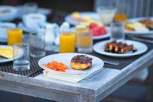 Delicious waffles, cake, coffee and juice served for breakfast at resort restaurant photo