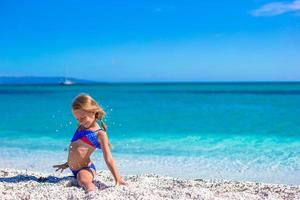 Little happy girl enjoying beach vacation photo