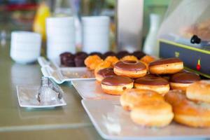 Different sorts of donats on breakfast in cafe photo