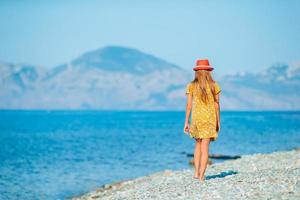 Cute little girl at beach during summer vacation photo