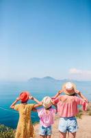 Adorable little girls and young mother on tropical white beach photo