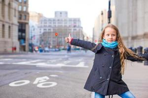 Adorable little girl get taxi at New York City photo