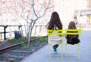 Adorable little girl and mother enjoy sunny day on New York's High Line photo