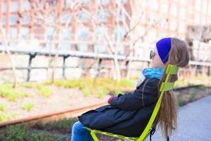 Adorable little girl enjoy sunny day on New York's High Line photo