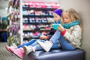 Little girls tired while doing shopping in shopping center photo