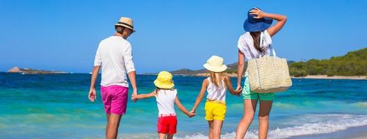 Happy family of four during beach vacation photo